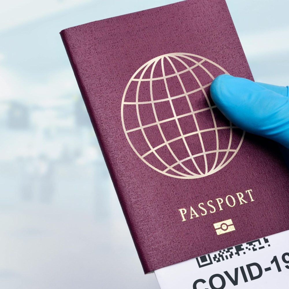 pexels photo 11623659 11623659 Close-up of a gloved hand holding a passport with a COVID-19 ticket, symbolizing pandemic travel.